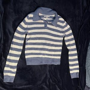Blue and white striped collared sweater.